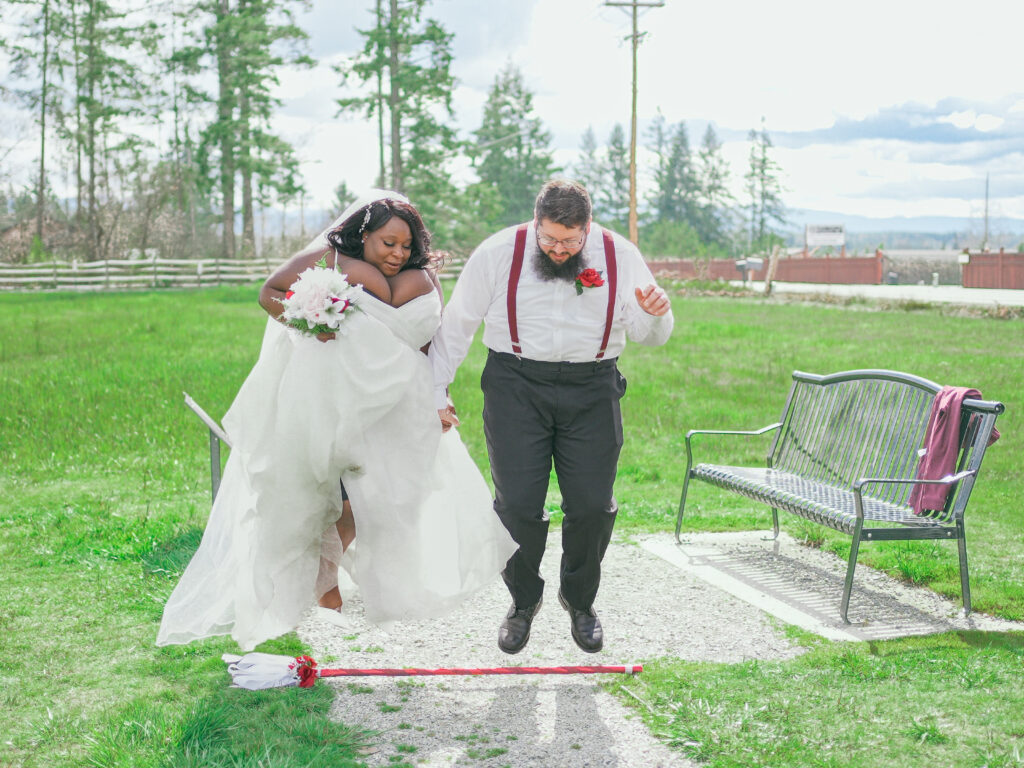 Bride and groom jumping the broom - Photo by 4Karma Studio