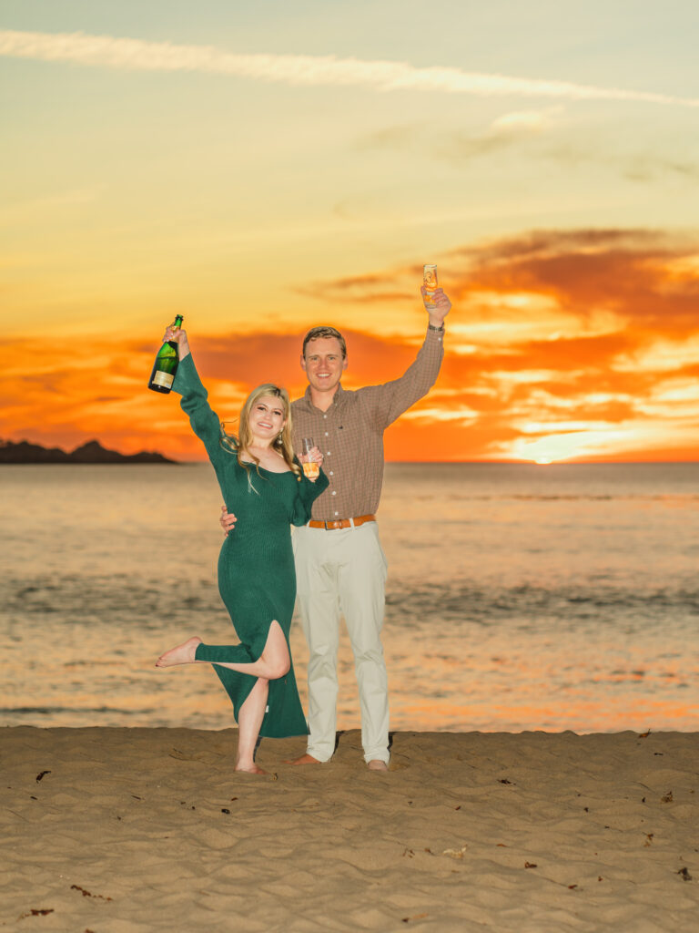 Couple portrait with champagne and glasses for a proposal at Carmel Beach - Carmel Beach Proposal: Top Photo Spots - photo by 4Karma Studio